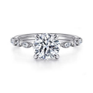 Gabriel & Co. ER16233R6W44JJ 14 karat white gold Victorian engagement ring, front view of a round center flanked by round and elongated diamonds in beaded surrounds