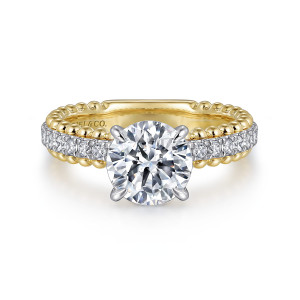 Gabriel & Co. ER16248R6M44JJ 14 karat white and yellow gold Bujukan engagement ring, front view of the round center with four prongs and beaded edges bordering the stone row
