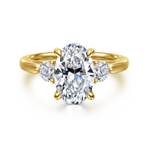 Gabriel & Co. ER16252O10Y44JJ 14 karat yellow gold Classic engagement ring, front view of an oval center with teardrop tipped prongs between round side stones