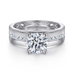 Gabriel & Co. ER16260R6W44JJ 14 karat white gold Contemporary engagement ring, front view of a round center above a broad, flat band with a channel of square diamonds