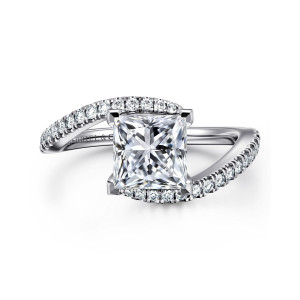 Gabriel & Co. ER16278S6W44JJ 14 karat white gold Contemporary engagement ring, front view of a princess cut center with diamond lined ends crossing past the head