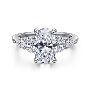 Gabriel & Co. ER16279O8W44JJ 14 karat white gold Contemporary engagement ring, front view of an oval center between stepped side stones and four claw prongs