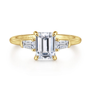 Gabriel & Co. ER16288E6Y44JJ 14 karat yellow gold Classic engagement ring, front view of an emerald cut center between tapered baguette diamonds and four claw prongs