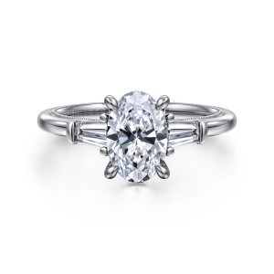 Gabriel & Co. ER16289O6W43JJ 14 karat white gold Classic engagement ring, front view of an oval center flanked by tapered baguette diamonds on the shoulders