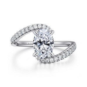 Gabriel & Co. ER16320O6W44JJ 14 karat white gold Contemporary engagement ring, front view of a crossing band with pave arms sweeping past the oval center