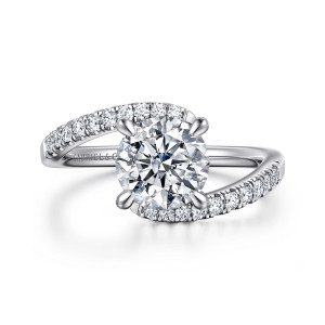 Gabriel & Co. ER16320R6W44JJ 14 karat white gold Contemporary engagement ring, front view of a round center held by band ends that curve past each other on opposite sides