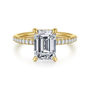 Gabriel & Co. ER16321E10Y44JJ 14 karat yellow gold Classic engagement ring, front view of an emerald cut center with a hint of halo stones behind its top edge
