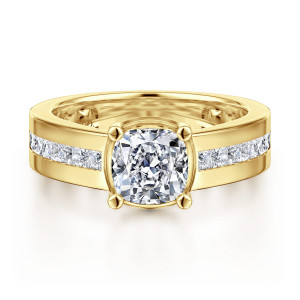 Gabriel & Co. ER16328C6Y44JJ 14 karat yellow gold Contemporary engagement ring, front view of a cushion cut center on a wide shank with channel set square stones