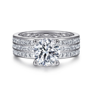 Gabriel & Co. ER16329R8W44JJ 14 karat white gold Contemporary engagement ring, front view of the round center and four ball tipped prongs above channel rows across the band
