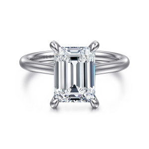 Gabriel & Co. ER16337E12W44JJ 14 karat white gold Contemporary engagement ring, front view of an emerald cut center with four rounded prongs on a plain slim band
