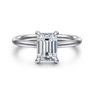 Gabriel & Co. ER16337E6W44JJ 14 karat white gold Contemporary engagement ring, front view of an emerald cut center in four teardrop tipped claws on a plain band