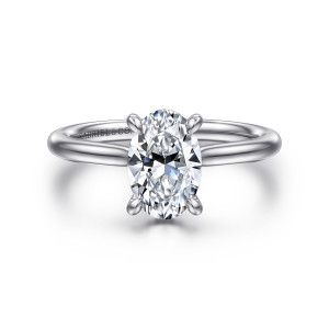 Gabriel & Co. ER16337O6W44JJ 14 karat white gold Contemporary engagement ring, front view of an oval center gripped by teardrop tipped claws above a smooth slim band