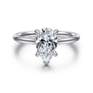 Gabriel & Co. ER16337P6W44JJ 14 karat white gold Contemporary engagement ring, front view of the pear center with a V shaped claw at its point on a plain band