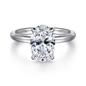 Gabriel & Co. ER16338O10W4JJJ 14 karat white gold Contemporary engagement ring, front view of an oval center in pointed prongs on a smooth band with a maker's mark
