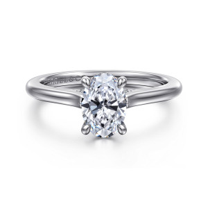 Gabriel & Co. ER16339O4W44JJ 14 karat white gold Classic engagement ring, front view of an oval center on four claws between shoulders that sweep up to the head