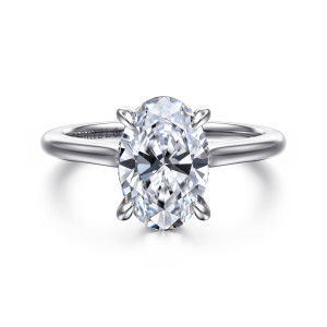 Gabriel & Co. ER16339O8W44JJ 14 karat white gold Classic engagement ring, front view of an oval center on slim claws above a smooth band that swells toward the head