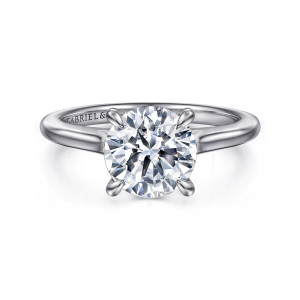 Gabriel & Co. ER16339R8W44JJ 14 karat white gold Classic engagement ring, front view of the round center in four claw prongs on a smooth band rising to the head