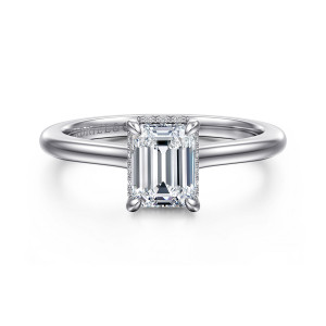Gabriel & Co. ER16340E4W44JJ 14 karat white gold Classic engagement ring, front view of an emerald cut center with claw corners and diamonds peeking at its edges