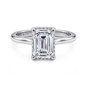 Gabriel & Co. ER16340E8W44JJ 14 karat white gold Classic engagement ring, front view of an emerald cut center with a thin edge of small diamonds peeking out beneath