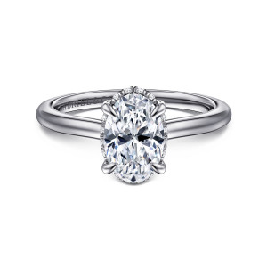 Gabriel & Co. ER16340O6W44JJ 14 karat white gold Classic engagement ring, front view of an oval center gripped by claw prongs above a smooth tapered band