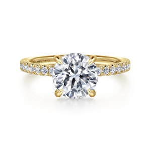 Gabriel & Co. ER16349R8Y44JJ 14 karat yellow gold Classic engagement ring, front view of a round center in four teardrop tipped prongs above small diamonds on the shoulders