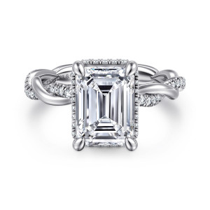 Gabriel & Co. ER16357E12W44JJ 14 karat white gold Contemporary engagement ring, front view of an emerald cut center with small diamonds showing at its edge between four claws