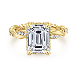Gabriel & Co. ER16357E12Y44JJ 14 karat yellow gold Contemporary engagement ring, front view of an emerald cut center framed by small diamonds with the twisting band curving away