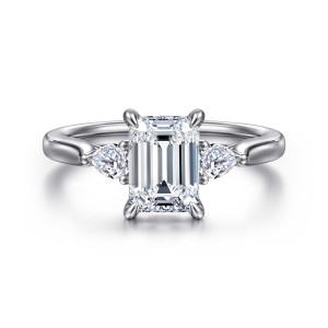 Gabriel & Co. ER16402E6W44JJ 14 karat white gold Lotus engagement ring, front view of an emerald cut center with slender claw prongs between two elongated side stones