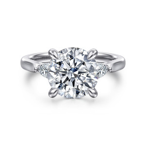 Gabriel & Co. ER16402R12W44JJ 14 karat white gold Lotus engagement ring, front view of a large round center in slim prongs with a small elongated diamond at each side