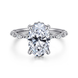 Gabriel & Co. ER16414O12W44JJ 14 karat white gold Contemporary engagement ring, front view of an oval center on four prongs with elongated stones running down the band