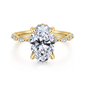 Gabriel & Co. ER16414O12Y44JJ 14 karat yellow gold Contemporary engagement ring, front view of an oval center with elongated stones and tiny beads running along both shoulders