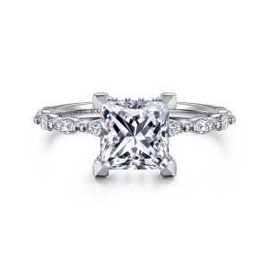 Gabriel & Co. ER16414S6W44JJ 14 karat white gold Contemporary engagement ring, front view of a princess cut center in flat-topped corner prongs above a thin band of elongated stones
