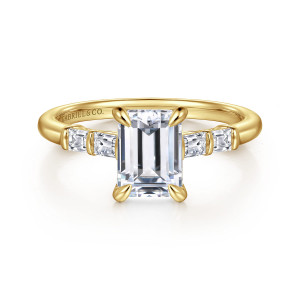 Gabriel & Co. ER16423E6Y44JJ 14 karat yellow gold Contemporary engagement ring, front view of an emerald cut center flanked by bar set baguette diamonds on a slim band