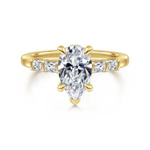 Gabriel & Co. ER16423P6Y44JJ 14 karat yellow gold Contemporary engagement ring, front view of a pear shaped center with a V shaped prong at its point between baguette shoulders