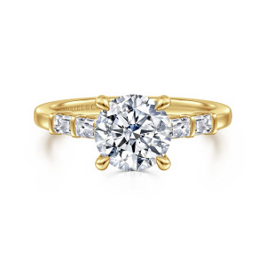 Gabriel & Co. ER16423R6Y44JJ 14 karat yellow gold Contemporary engagement ring, front view of a round center in four prongs with baguette stones on each shoulder