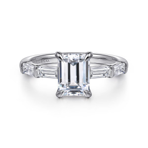 Gabriel & Co. ER16424E6W44JJ 14 karat white gold Contemporary engagement ring, front view of an emerald cut center with baguette diamonds set sideways along the shoulders