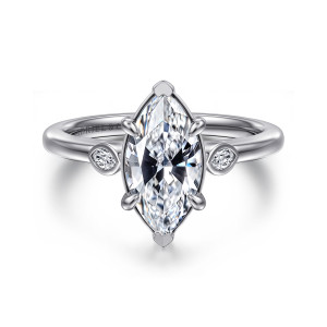 Gabriel & Co. ER16429M6W43JJ 14 karat white gold Contemporary engagement ring, front view of a marquise center with tip caps and a small pointed bezel stone beside the head