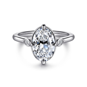 Gabriel & Co. ER16429O8W43JJ 14 karat white gold Contemporary engagement ring, front view of an oval center with pointed claw prongs and a small bezel stone at each shoulder