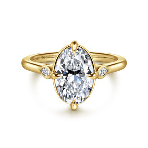 Gabriel & Co. ER16429O8Y43JJ 14 karat yellow gold Contemporary engagement ring, front view of an oval center in a thin rim, with small bezel stones at each side