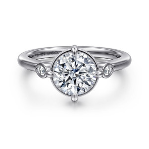 Gabriel & Co. ER16429R6W43JJ 14 karat white gold Contemporary engagement ring, front view of prongs at the compass points around a round center and bezel stones beside it