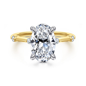 Gabriel & Co. ER16431O12M44JJ 14 karat white and yellow gold Contemporary engagement ring, front view of a tall oval center on four prongs with round diamonds flanking the head