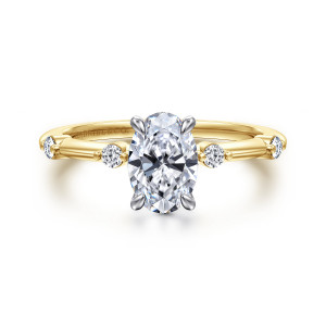 Gabriel & Co. ER16431O4M44JJ 14 karat white and yellow gold Contemporary engagement ring, front view of an oval center in four rounded prongs with round diamonds spaced along a slim band