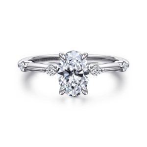 Gabriel & Co. ER16431O4W44JJ 14 karat white gold Contemporary engagement ring, front view of an oval center in four claw prongs flanked by small round diamonds spaced apart