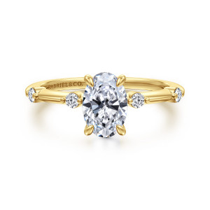 Gabriel & Co. ER16431O4Y44JJ 14 karat yellow gold Contemporary engagement ring, front view of an upright oval center beside round diamonds framed by tiny beads on a thin band