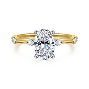 Gabriel & Co. ER16431O6M44JJ 14 karat white and yellow gold Contemporary engagement ring, front view of an oval center with a paler head above round stones spaced along the shoulders