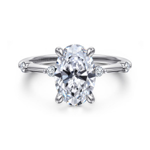 Gabriel & Co. ER16431O8W44JJ 14 karat white gold Contemporary engagement ring, front view of a tall oval center in four claw prongs with round diamonds on each shoulder