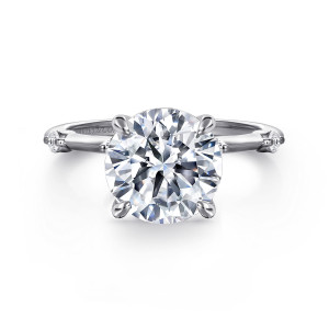Gabriel & Co. ER16431R12W44JJ 14 karat white gold Contemporary engagement ring, front view of a round center in slender prongs with small stones at the edges of the band
