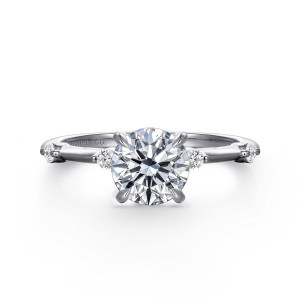 Gabriel & Co. ER16431R4W44JJ 14 karat white gold Contemporary engagement ring, front view of a round center in rounded prongs with round diamonds spaced along the slim band