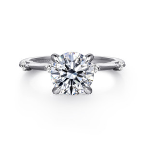 Gabriel & Co. ER16431R8W44JJ 14 karat white gold Contemporary engagement ring, front view of a round center in claw prongs with small round diamonds spaced on the thin band