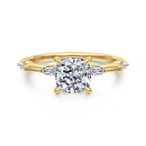 Gabriel & Co. ER16432C6Y43JJ 14 karat yellow gold Starlight engagement ring, front view of a cushion center flanked by elongated stones laid lengthwise on a slim band